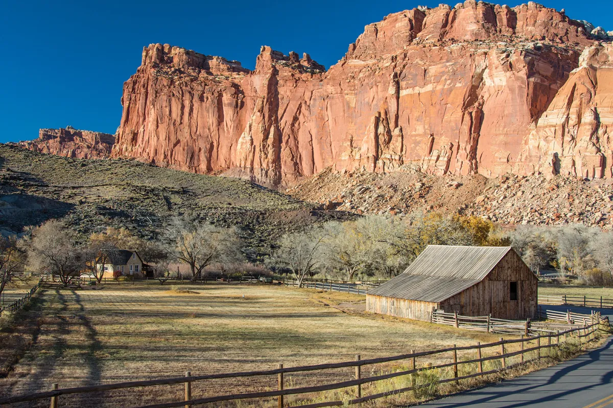 Wingate Sandstone cliffs behind historic barn and farmhouse