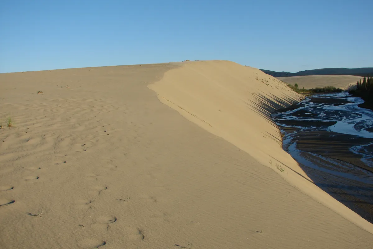 sun setting on sand dunes