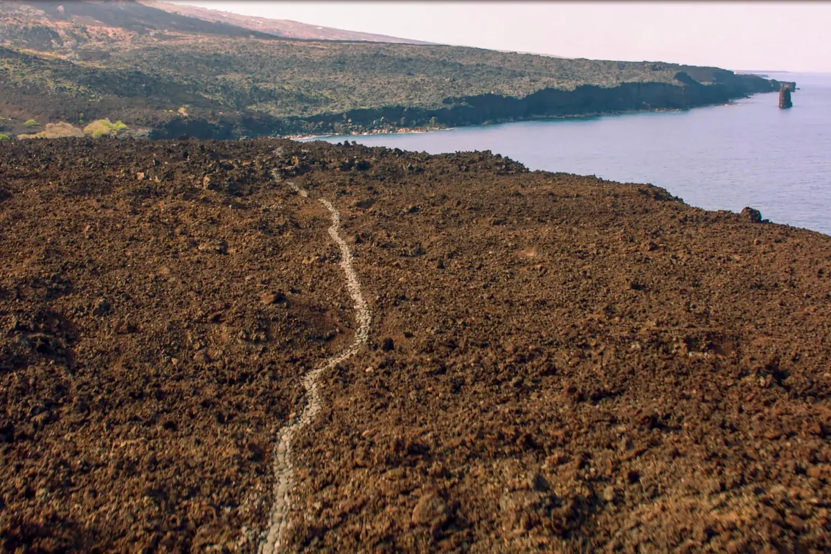 Aerial photograph of trail through lava along the Hawaiian Coast