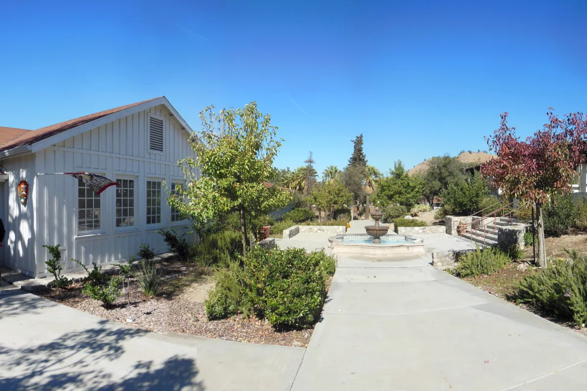 A walkway with a fountain