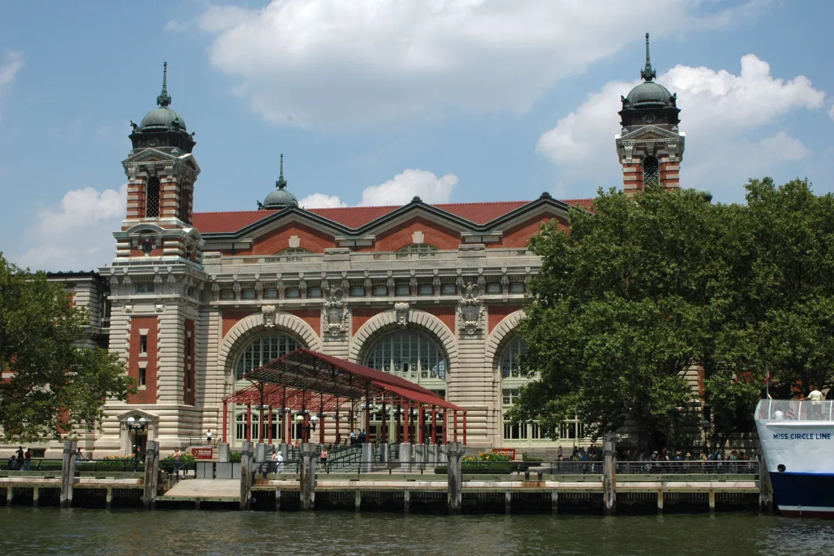 Beaux-Arts brick and limestone building with large arched windows and cupola-topped towers.
