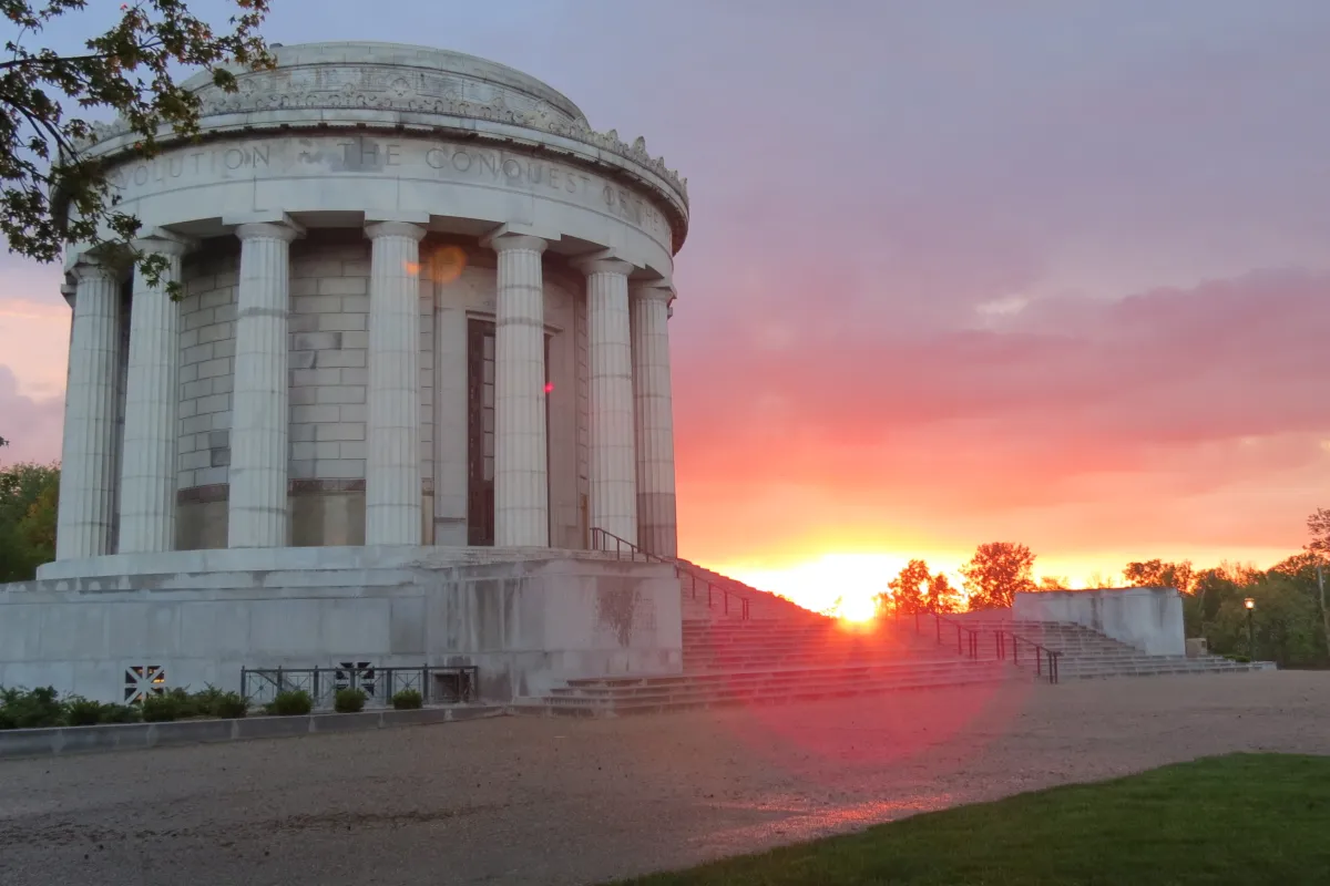 Sun setting behind the Clark Memorial