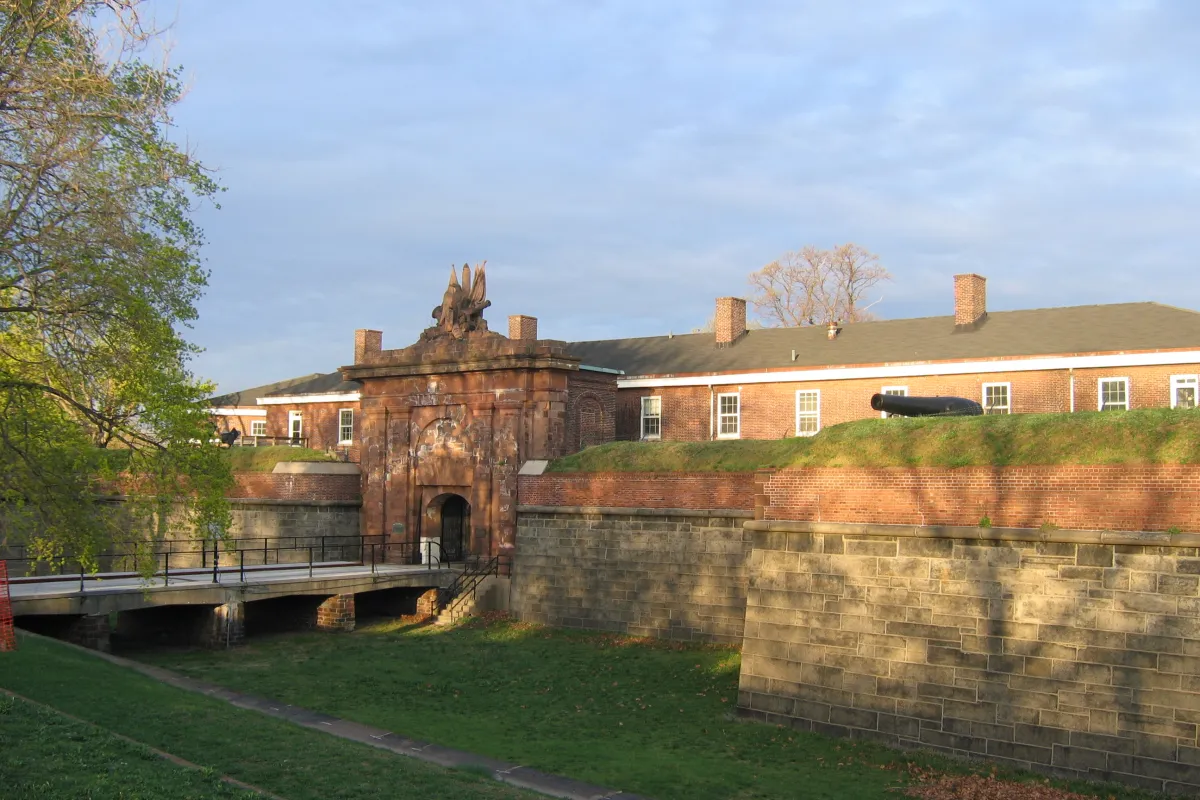 Bridge over dry moat leading into a gated fort.