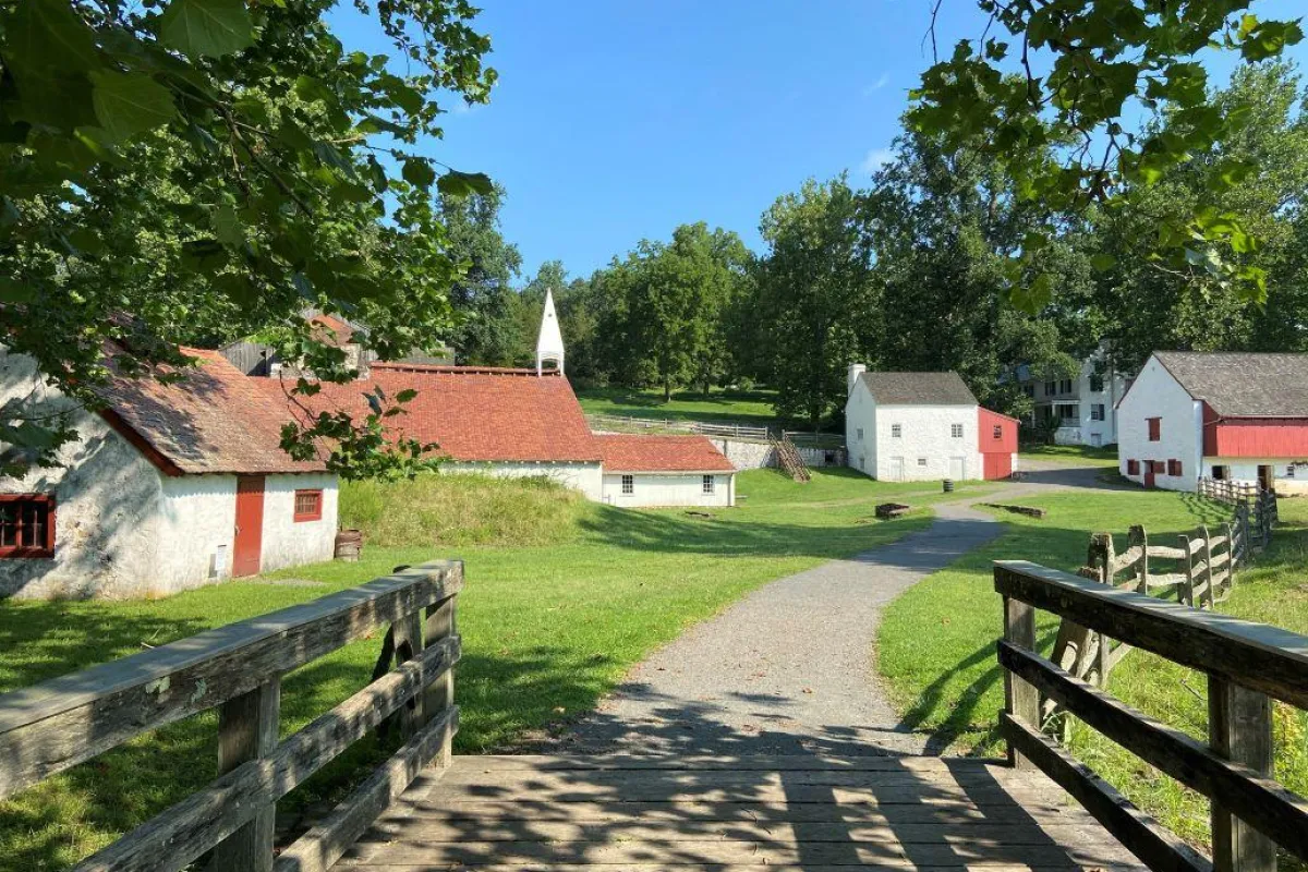 buildings varying in size on either side of a gravel path.