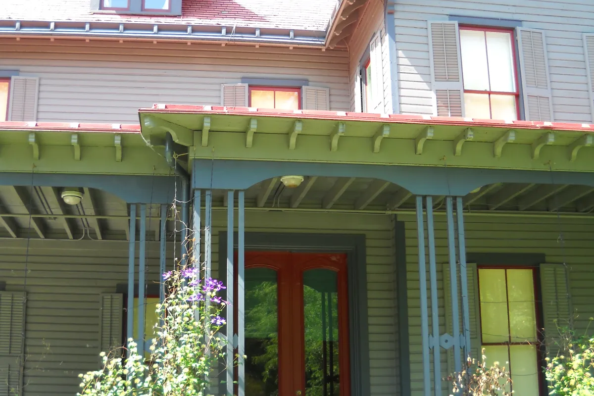 Front porch of Garfield home showing red front door
