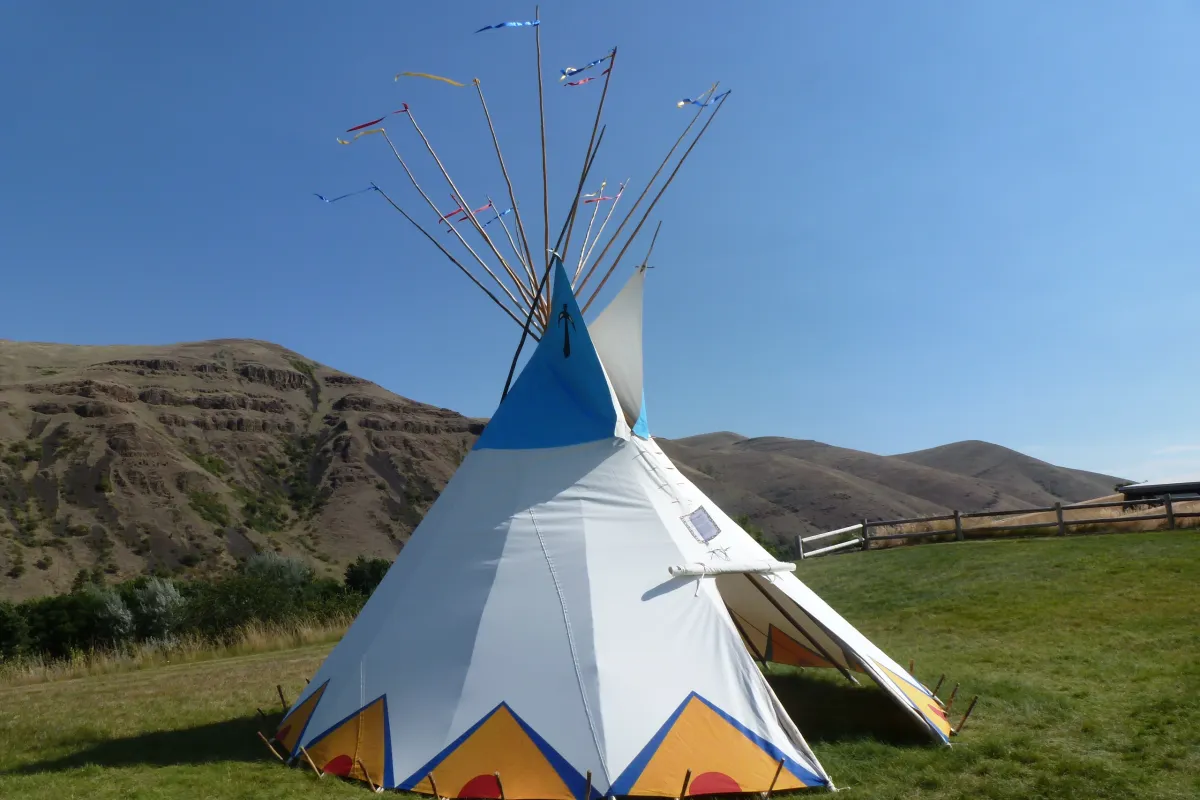 Colorful painted tipi on green lawn