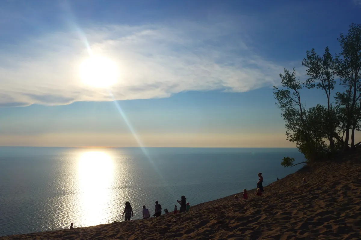 A bright sun begins to set into Lake Michigan