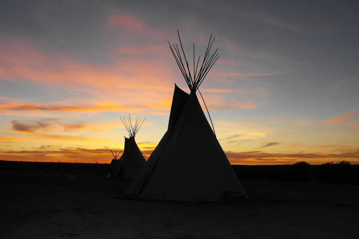 Cheyenne tipis backlite by sunset